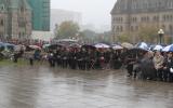 2012 Memorial Service - guests at memorial service in the rain with umbrellas (4)
