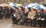 2012 Memorial Service - guests at memorial service in the rain with umbrellas (5)